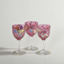 Three Antique Moser style ruby sherry or port glasses with enamelled leaves, vines and flowers